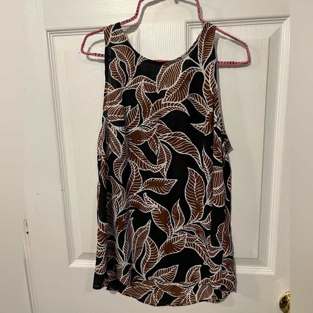 Leaf print high neck blouse with zipper closure in the back.